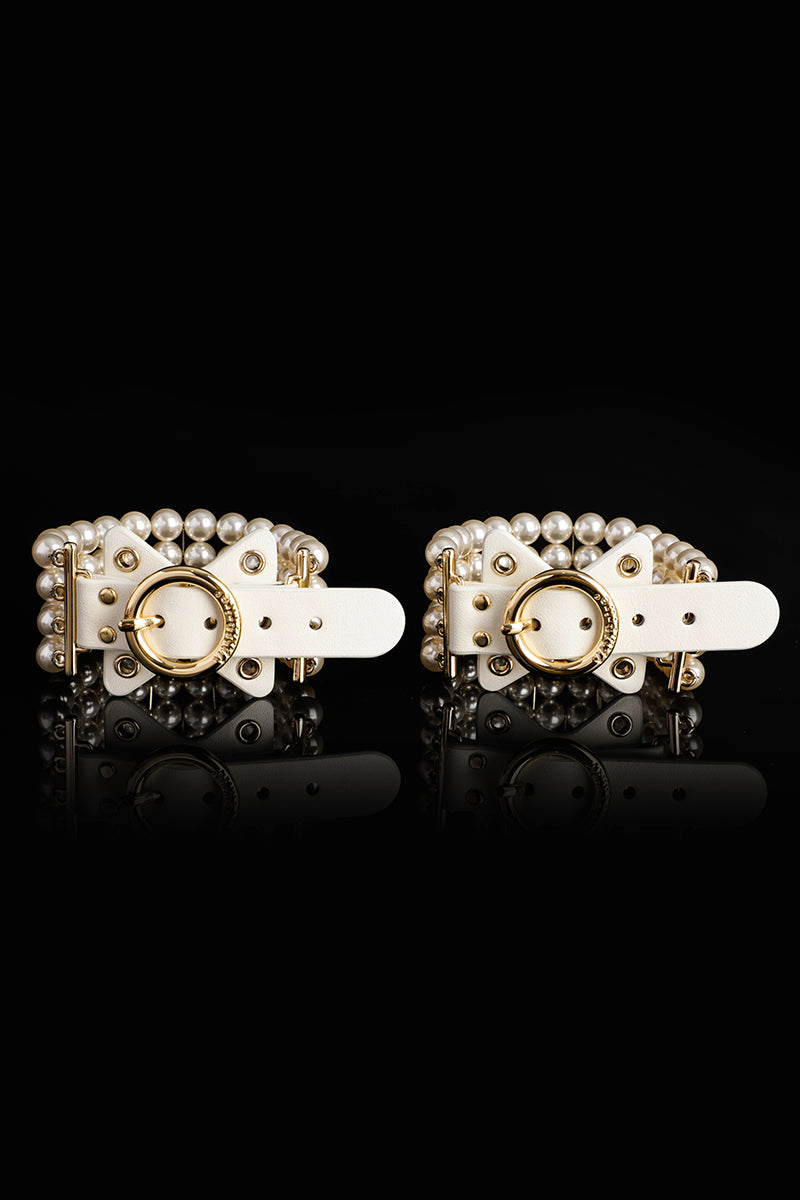 ETHREAL RADIANCE: PEARL HANDCUFFS WITH LEATHER AND GOLD HARDWARE