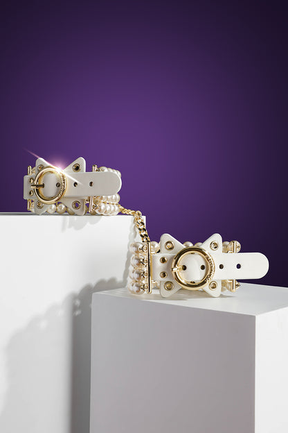 ETHREAL RADIANCE: PEARL HANDCUFFS WITH LEATHER AND GOLD HARDWARE