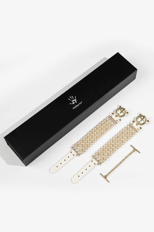 ETHREAL RADIANCE: PEARL HANDCUFFS WITH LEATHER AND GOLD HARDWARE